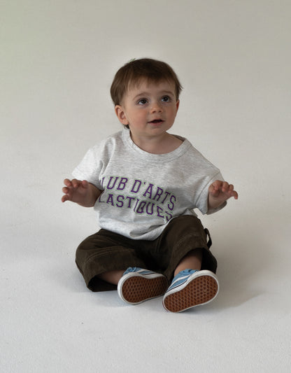 Baby wearing an oversized t-shirt with varsity logo 100% cotton oversized kidswear 
